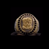 Japanese 18K gold lion statement ring featuring sculpted lion design and black gemstone details